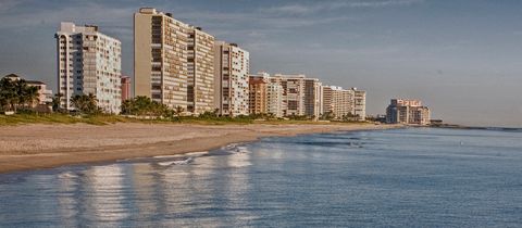 Condo towers along the beach above calm water