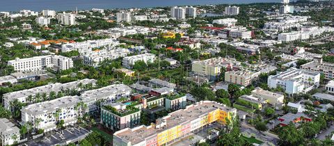 Low-rise Delray Beach from above, with colorful new buildings in front and condo buildings by the ocean behind