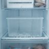An empty ice bin in an open freezer