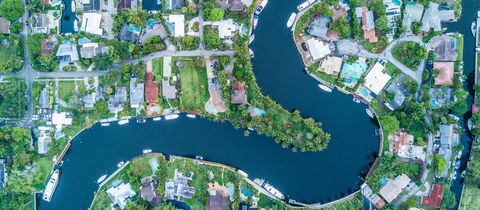 Houses and docked boats along a winding canal in Fort Lauderdale’s Tarpon River neighborhood, seen from directly above