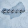 Ice cubes fused into one frosty clump around the auger of an ice bin