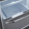 An empty ice bin in a pulled-out freezer drawer