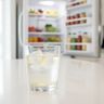 A glass of iced water with cloudy, slightly yellow ice cubes