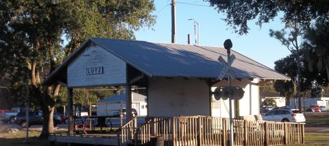 The rebuilt Lutz depot and its LUTZ sign under live oaks