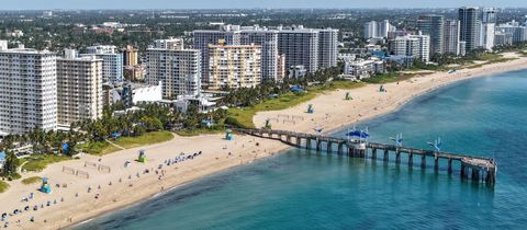 The Fisher Family Pier reaching out from Pompano Beach, with the row of beach condo towers behind the sand