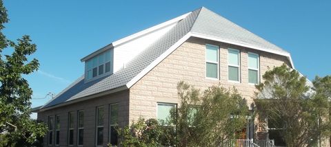 The Palm Harbor Museum under its grey hip roof and dormer