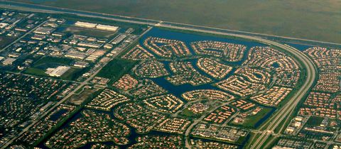 Lake communities beside the curve of the Sawgrass Expressway, the Everglades along the top