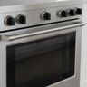 The front control knobs of a stainless slide-in range, above the oven door