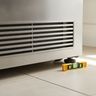 The bottom grille and leveling foot of a refrigerator, with a spirit level on the floor