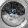 Suds and water standing behind the closed glass door of a front-load washer