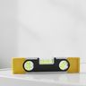 A spirit level lying on top of a white washing machine