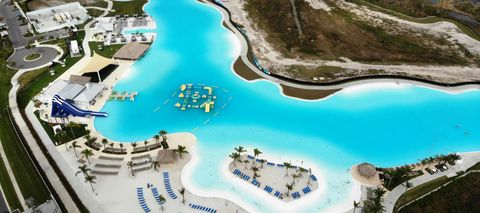 A turquoise lagoon and white sand beach in Wesley Chapel, from a drone