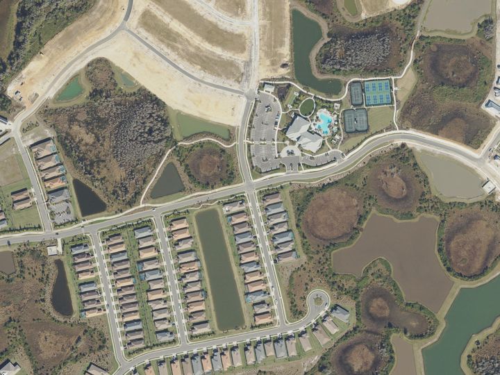 Rows of new homes, ponds and a community clubhouse at Wiregrass Ranch, Wesley Chapel, seen from above