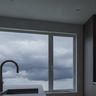A dim kitchen on a stormy day, the lights off and gray light coming through the window